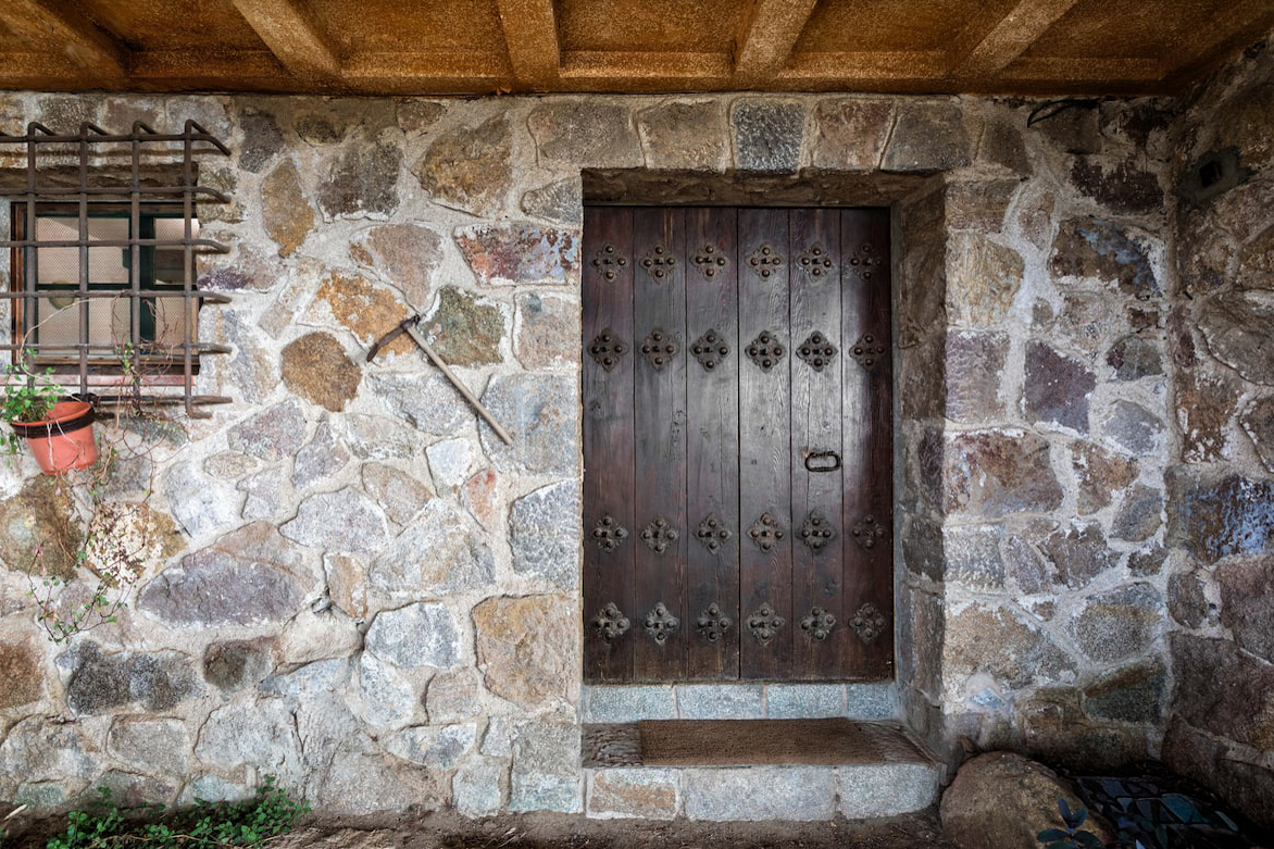 The private entrance: an old wooden door in a stone wall
