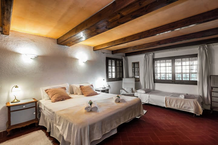 The master bedroom with beamed ceiling and terracotta floor