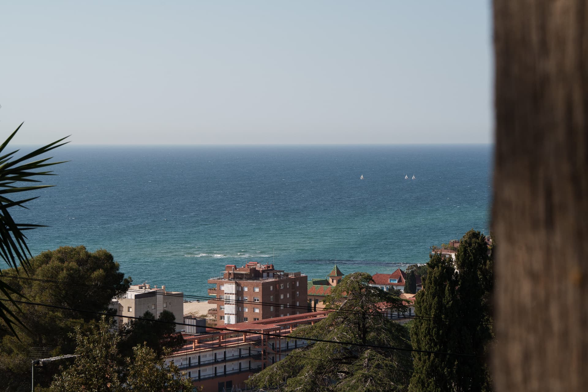 The village rooftops and the turquoise sea beyond